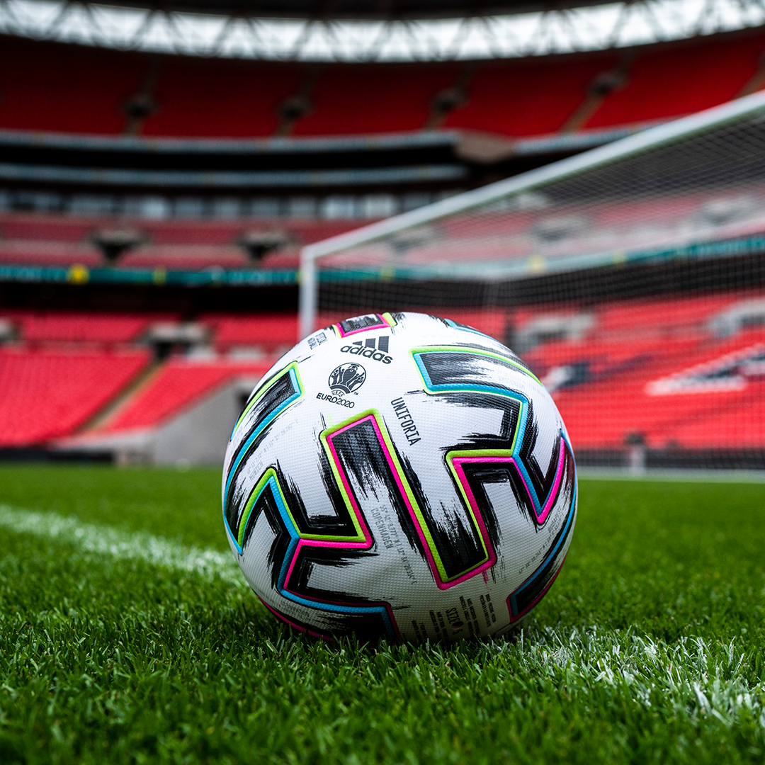 Modern sports facility with athletes training on indoor basketball court and weightlifting area